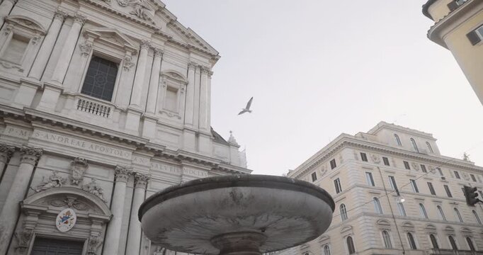 The Fountain of Sant'Andrea della Valle and the Basilica of Sant'Andrea della Valle in Rome in the background.