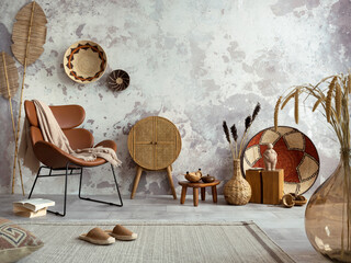 Interior design of ethnic living room interior with design leather brown armchair, colorful baskets.
