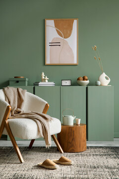 Elegant living room interior design with mockup poster frame, modern frotte armchair, wooden commode and stylish accessories. Eucalyptus wall. Template. Copy space.
