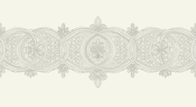 Intricate scrolling paisley and floral lace border in muted grey on cream
