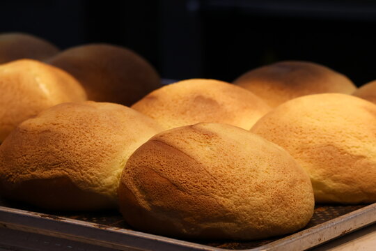 Freshly baked bread just out of the oven, golden crust, soft texture, warm aroma filling