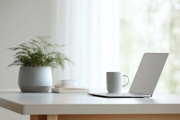 Fototapeta premium Stylish workspace desk with laptop and indoor plants near window