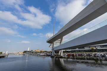 Fototapeta premium Modern bridge spans serene waterway beneath blue sky