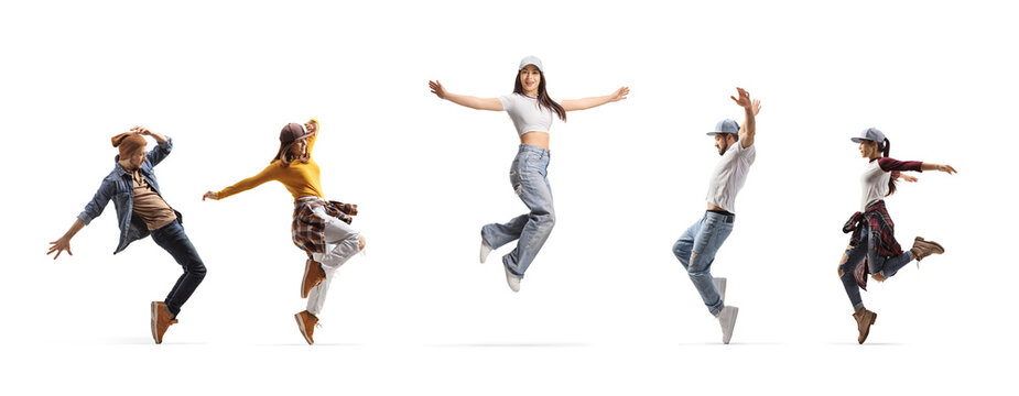 Young woman jumping with arms wide open and dancers dancing