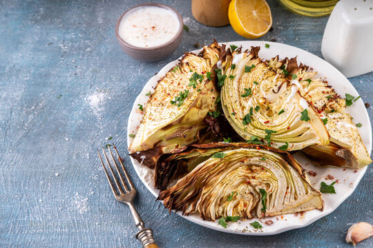 Roasted baked cabbage with cheese and aromatic herbs