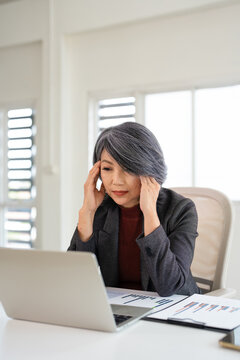 Business, headache and woman in office, laptop and tired with fatigue, exhausted. Stress, person and employee in workplace. migraine with anxiety, pressure and bankruptcy