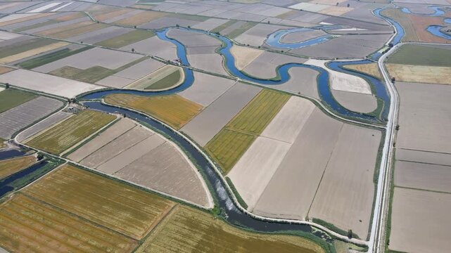 Large agricultural areas containing cotton, corn, and sunflower fields. The footage of the meanders flowing through these agricultural lands.
