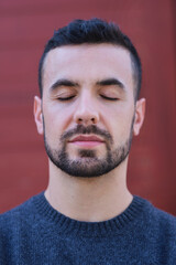 Obraz premium close up portrait of Man closing his eyes relaxing, meditating, feeling peaceful and calm