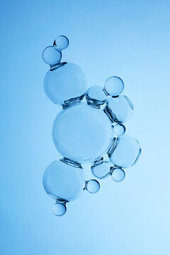 Abstract cosmetic lab. Water bubbles forming molecular structure on blue background