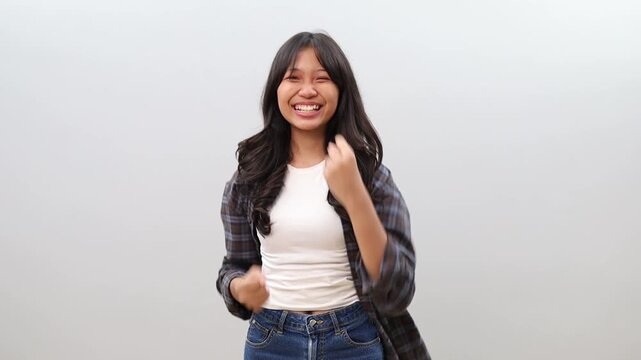 Wow happy excited happy Asian girl shouting and raising hands with excitement, successful concept