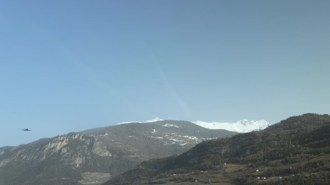 Static Shot of a Gulfstream Private Jet Flying By in the Mountains