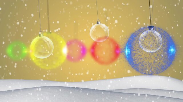 Colorful baubles hanging and snow falling on winter landscape against yellow background