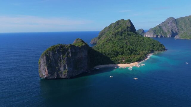 drone approach Helicopter Island in the Bacuit Archipelago, el nido Palawan during a sunny clear sky day