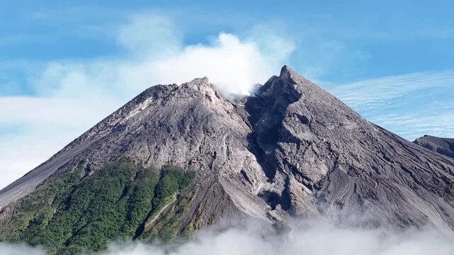 4K aerial footage showing the peak of Mount Merapi Yogyakarta, with clear blue sky.