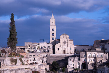 Obraz premium The Cathedral of Matera, Italy, rises above the Sassi, a Romanesque crown of stone watching over centuries of history.