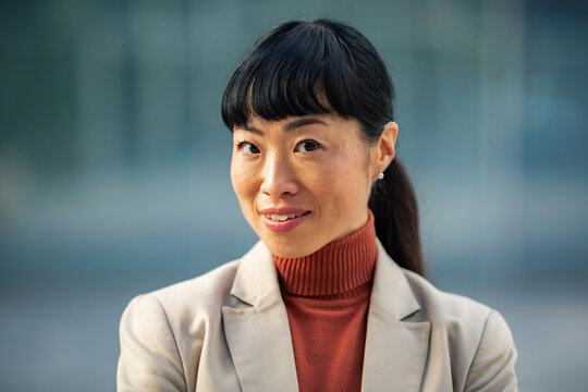 Confident businesswoman portrait outdoors in city