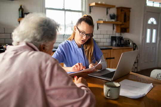 Caregiver reviewing paperwork with senior at home