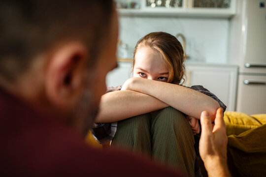 Teen girl and parent having difficult conversation at home