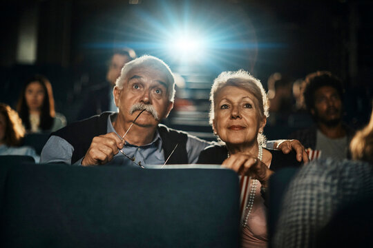 Senior couple watching a movie at the cinema