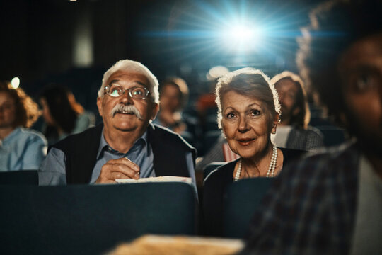 Senior couple watching a movie at the cinema