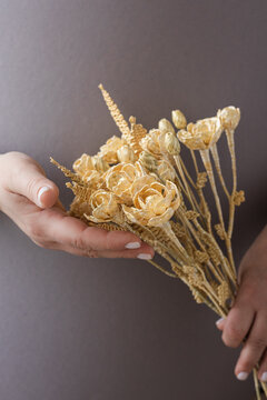 Wedding bouquet of flowers made of straw in female hands