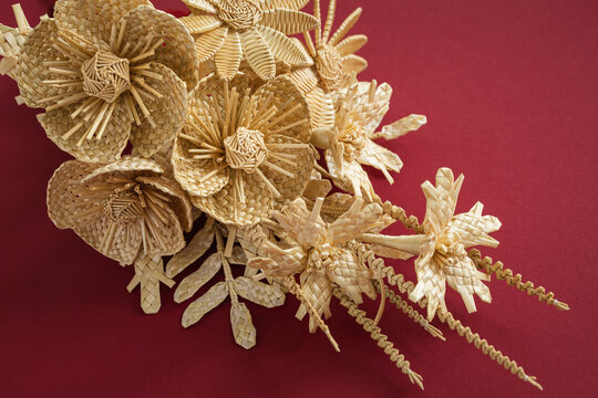 Wedding bouquet of flowers made of straw on a red background