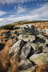 Fototapeta premium Stone cairn on mountain trail in Ukrainian Carpathians under blue sky