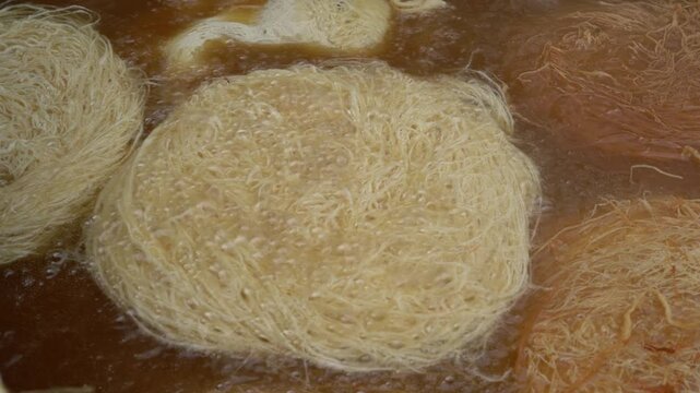 Traditional turkish kadaif dessert frying in hot oil