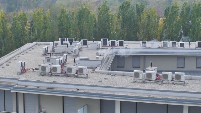 A smoking chimney on top of a hotel during heating the building with gas