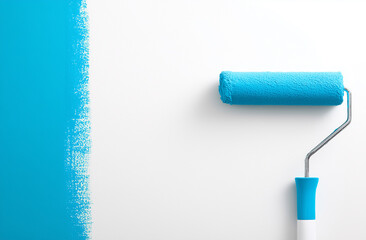 Obraz premium Blue paint roller on white wall, Home renovation. DIY house painting and interior decorating concept
