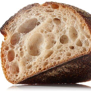 Crusty bread loaf cut in half showing airy crumb texture