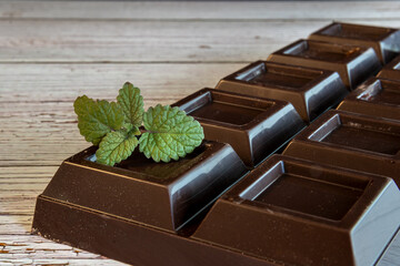 mint leaves on dark chocolate bar © Ijordan