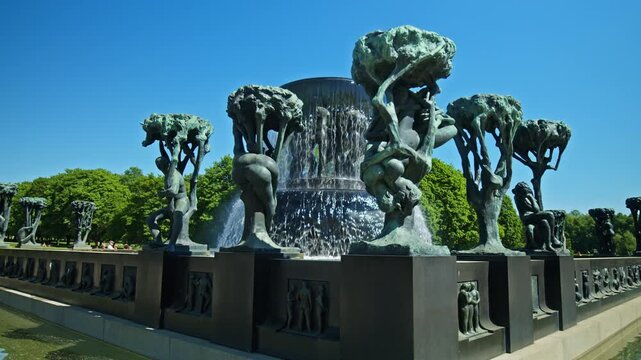 Bronze sculptures and cascading water at the Vigeland Fountain in Vigeland Sculpture Park. Sculpture figures and fountain basin during summer in Oslo, Norway.