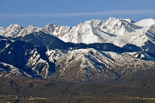 Scenic urban panorama of Almaty city landmarks with snow covered peaks of Trans-Ili Alatau mountains