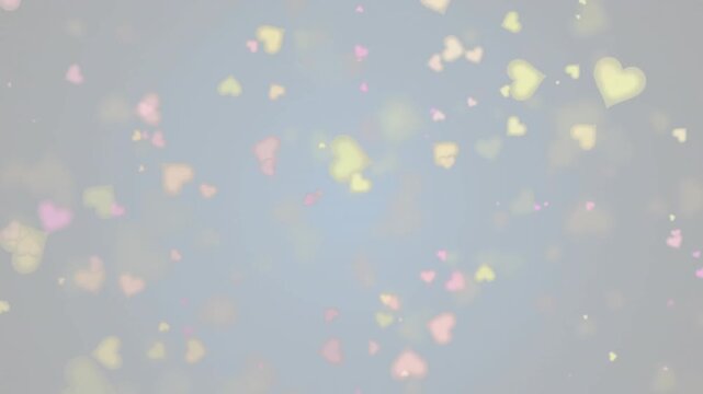 Floating colorful heart shapes on soft, blurred background in animation style