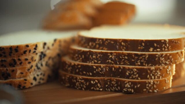 Sliced toast bread topped sesame seeds rests kitchen cutting board, evoking warm, inviting home cooking atmosphere kitchen table, as ingredients await preparation, reflecting cozy domestic setting