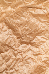Fototapeta premium Texture of crumpled brown paper. Baking paper or vintage aged parchment, abstract background. Wallpaper for writing text and lettering. Backdrop for your design
