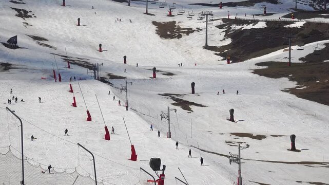 Skiers glide down snowy slopes