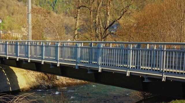 A bridge crosses a river surrounded by trees