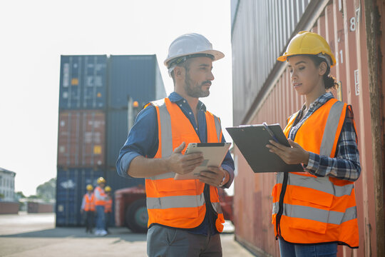 Two construction workers using tablet and clipboard at shipping container site

Keywords (45):