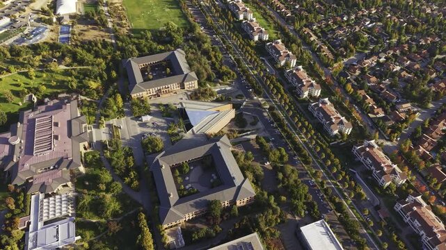 Top-down aerial drone view descending towards the modern courtyards of Universidad de los Andes, San Carlos de Apoquindo, Las Condes, Chile, 4K.