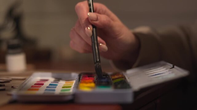 Calm And Deliberate Artist Carefully Samples Energetic Watercolor Pigments To Add Highlights And Accents. Media