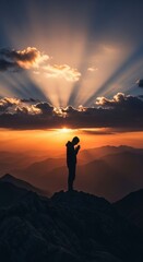 Obraz premium Person standing on mountain peak at sunrise.