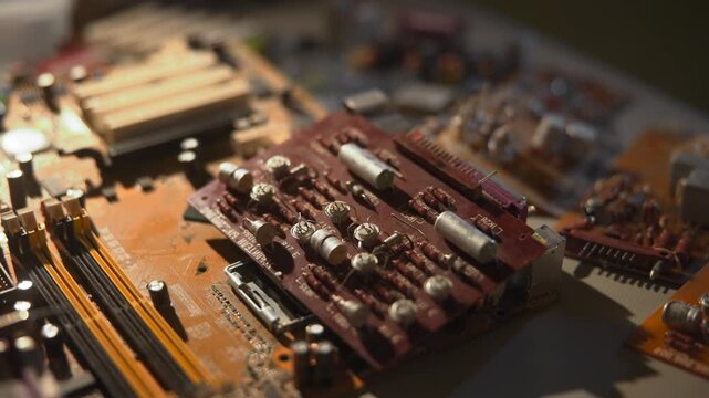 Analyzing Capacitor Setup Under Light. Technician Reviews Wiring And Capacitor Arrangement Meticulously. Media