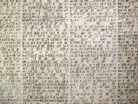 Ancient Assyrian cuneiform script carved stone; a high-detail Mesopotamian background featuring authentic wedge-shaped writing and archaeological historical inscriptions, history stock photo