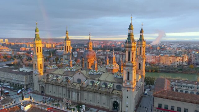 Aerial View Capturing Sunset Glow Illuminating Cathedral Domes And Tranquil River Reflections. Zaragoza. Spain 