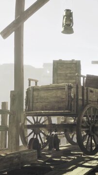 A wooden cart rests beneath a hanging lantern in a rural area during daylight. The scene shows a quiet place with structures in the background, indicating human presence.