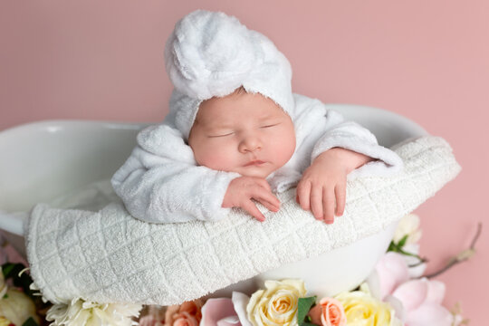 Newborn Baby Sleeping Peacefully in Bathtub with Spa Towel