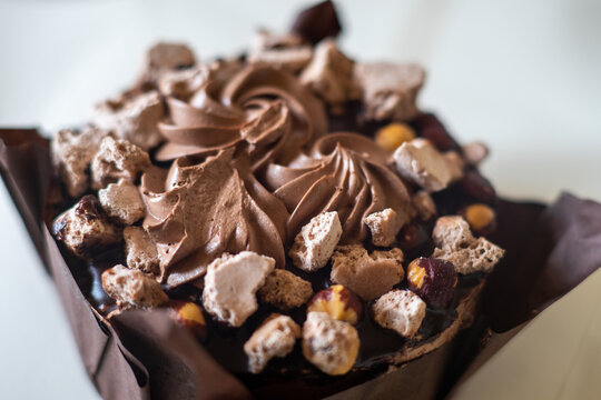 Chocolate cake topped with hazelnuts and meringue