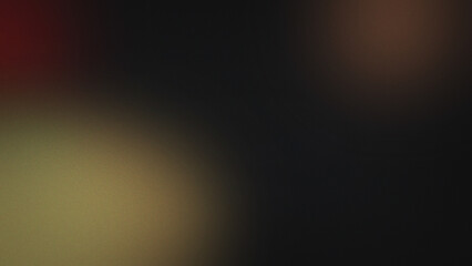 Obraz premium Dark abstract background with soft grainy texture and subtle blurred gradients in muted red brown and yellow tones on a deep black base